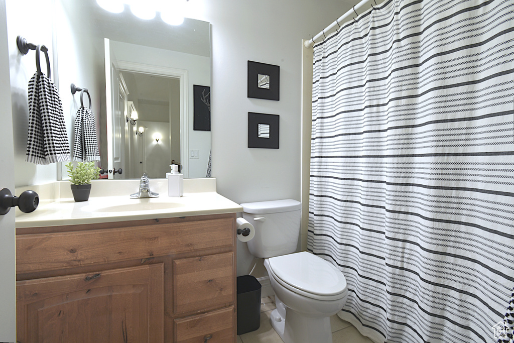 Bathroom with tile patterned flooring, vanity, and toilet