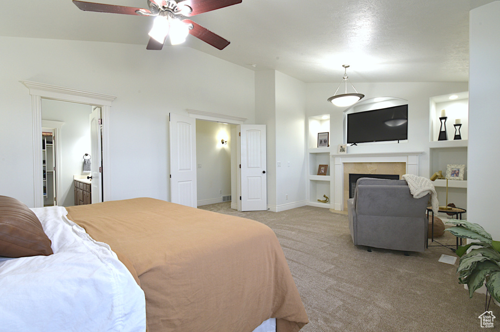 Carpeted bedroom with lofted ceiling, ensuite bath, and ceiling fan