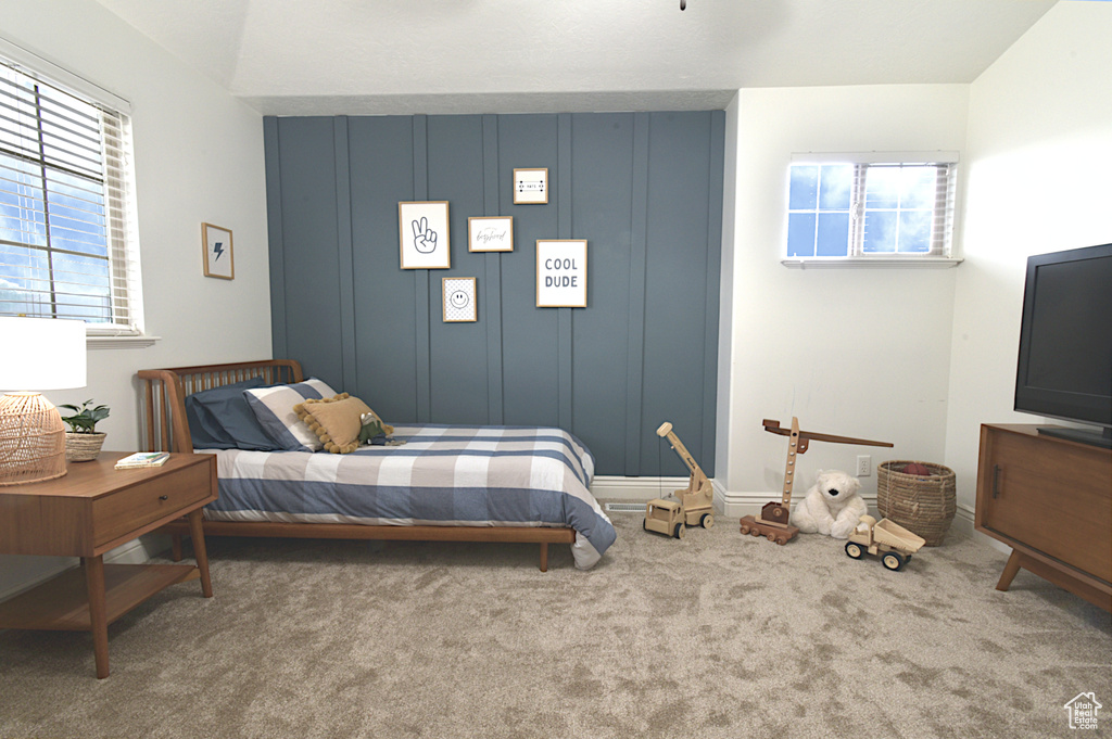 Carpeted bedroom with multiple windows