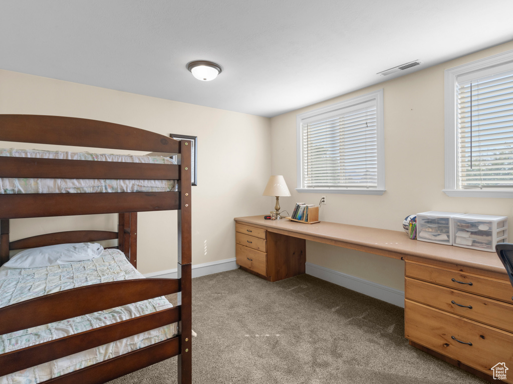 Bedroom featuring light colored carpet