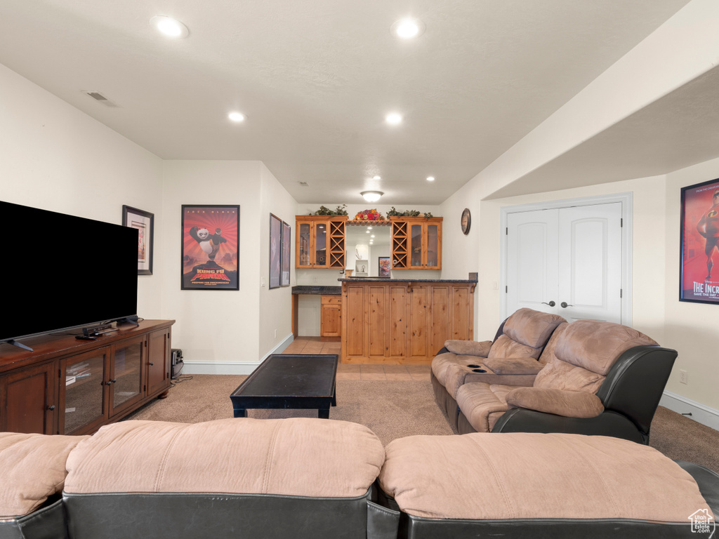 Living room featuring light colored carpet and bar