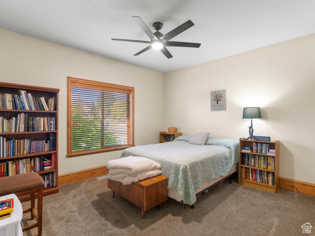 Bedroom with ceiling fan and carpet flooring