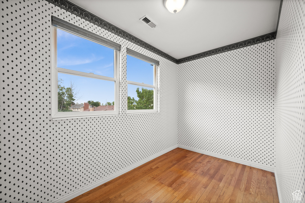 Unfurnished room with hardwood / wood-style floors