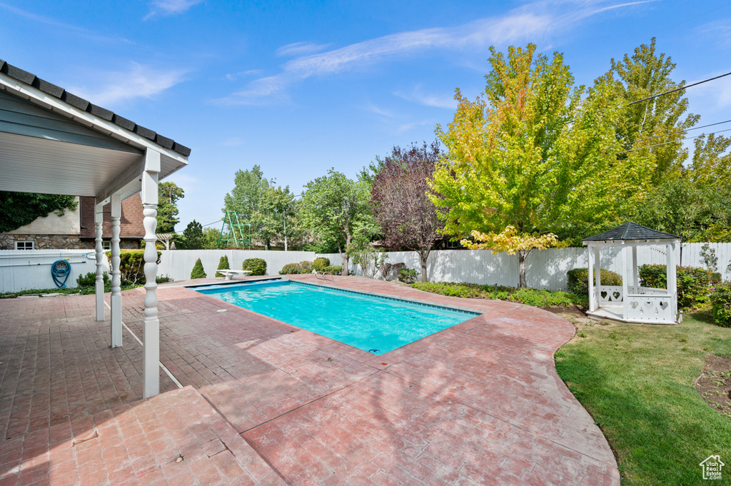 View of swimming pool with a patio and a gazebo