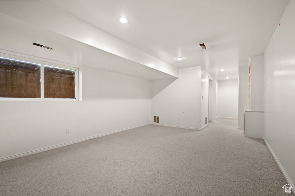 Basement with light colored carpet