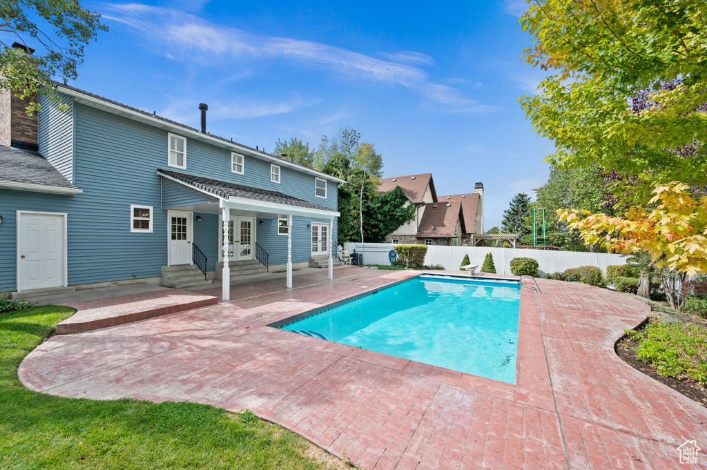 View of swimming pool with a patio