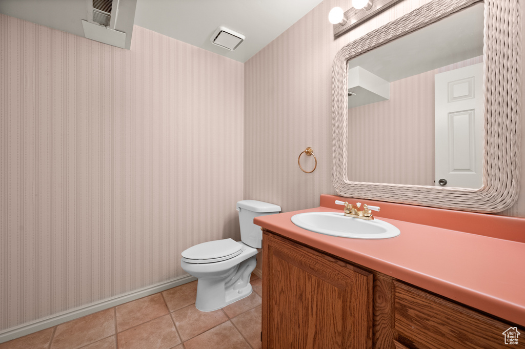 Bathroom with vanity, tile patterned flooring, and toilet