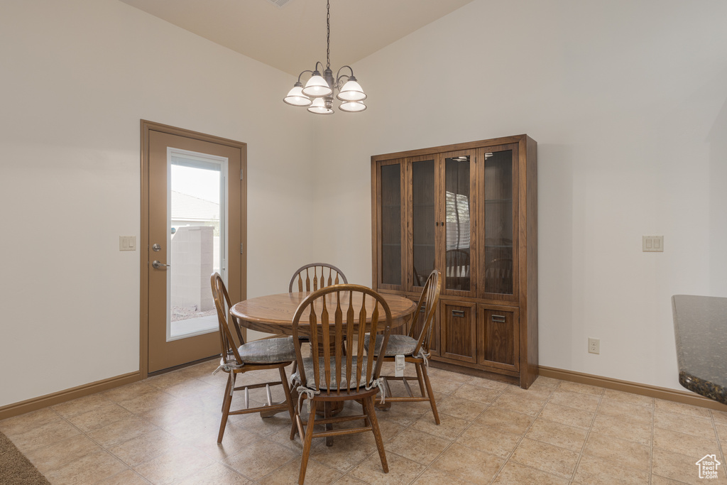 Dining space featuring lofted ceiling and an inviting chandelier