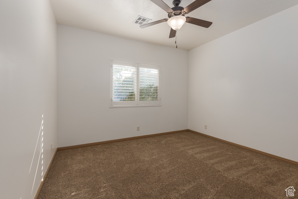 Unfurnished room with ceiling fan and carpet