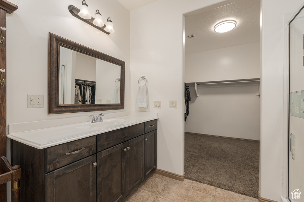 Bathroom with vanity and a textured ceiling