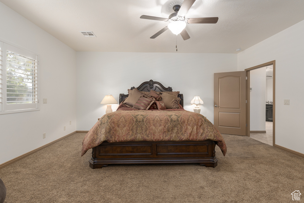 Bedroom featuring ceiling fan and carpet floors