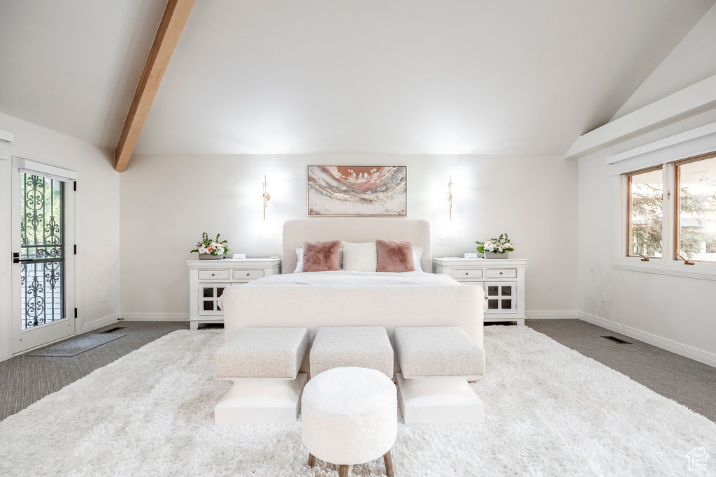 Bedroom with lofted ceiling with beams, access to outside, and carpet flooring