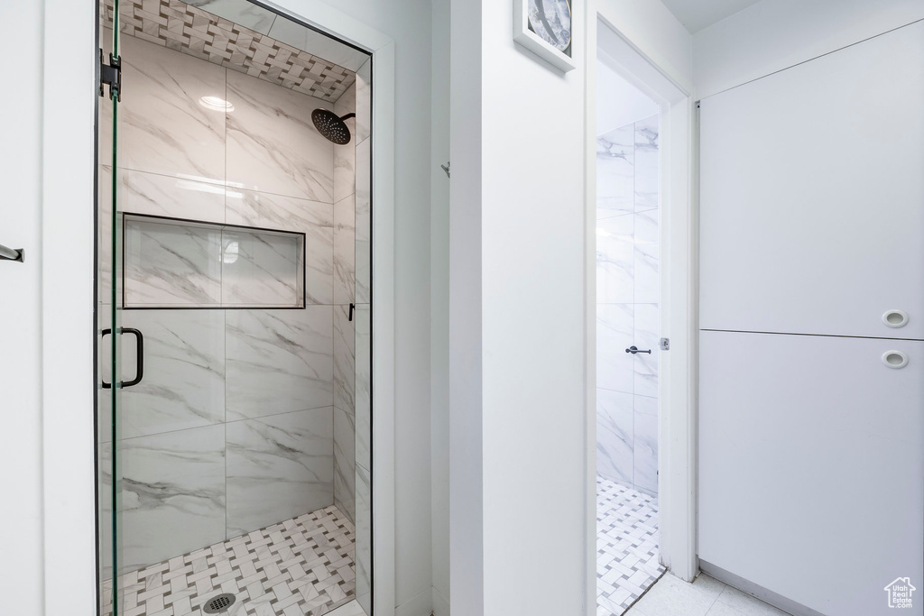 Bathroom featuring tile patterned flooring and a shower with door