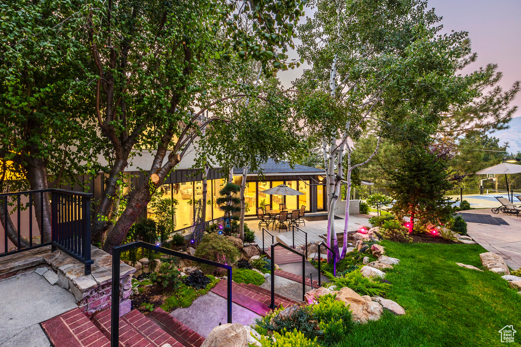 View of front of house featuring a gazebo, a lawn, and a patio