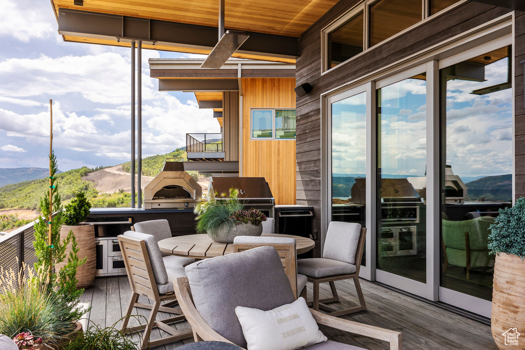 Sunroom with wood ceiling and a mountain view