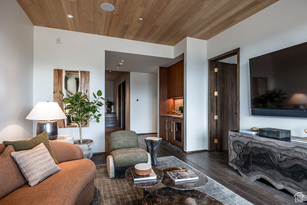 Living room with dark wood-type flooring and wooden ceiling