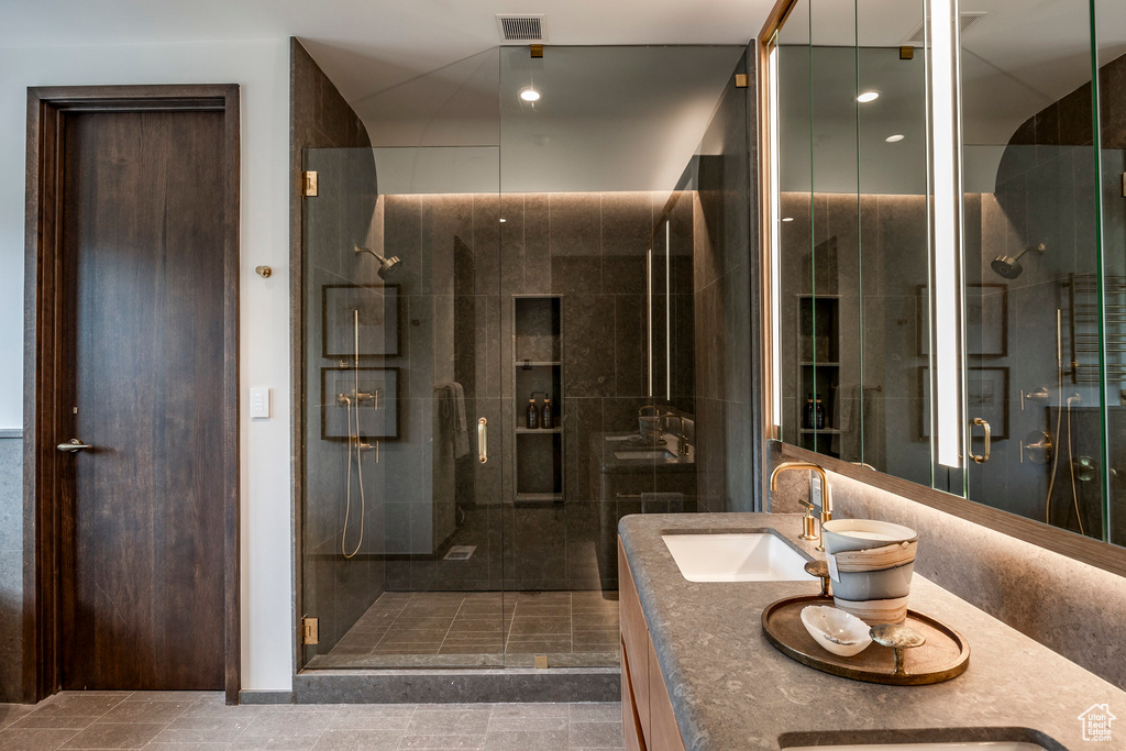 Bathroom with vanity and a shower with shower door