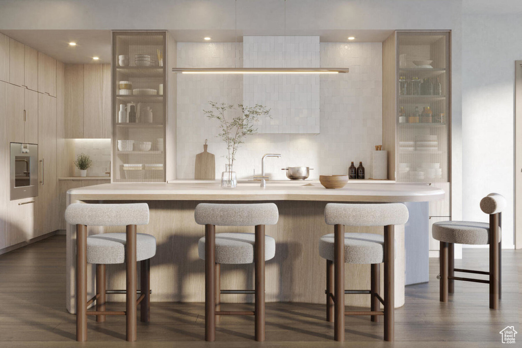 Bar featuring sink, backsplash, dark hardwood / wood-style flooring, and stainless steel oven