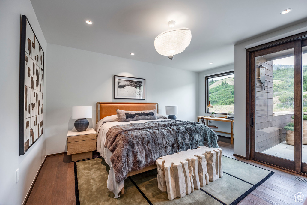 Bedroom featuring hardwood / wood-style flooring and access to outside