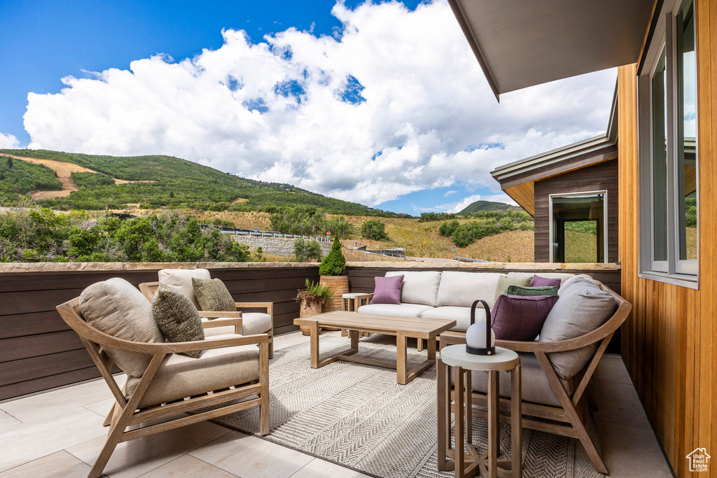 View of patio featuring a mountain view and an outdoor hangout area