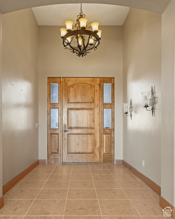 Foyer featuring a chandelier and light tile patterned floors