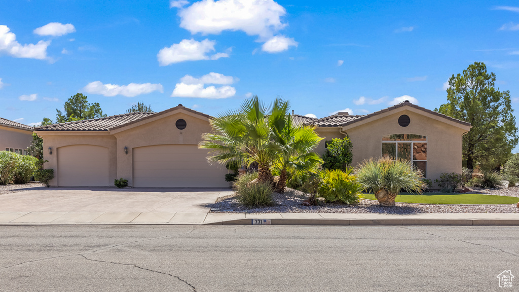 Mediterranean / spanish-style home with a garage