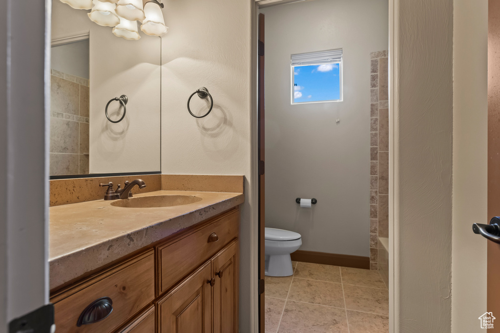 Full bathroom with shower with separate bathtub, tile patterned flooring, vanity, and toilet