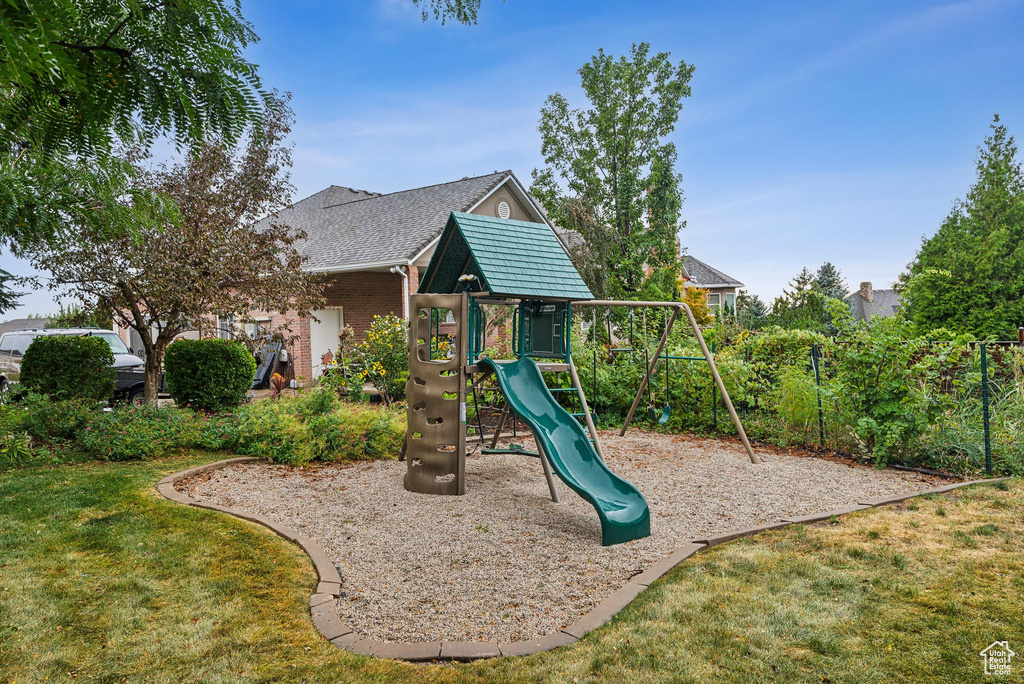 View of playground featuring a lawn