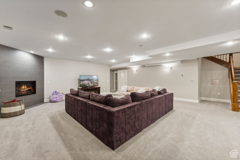 Living room with a tiled fireplace and light colored carpet