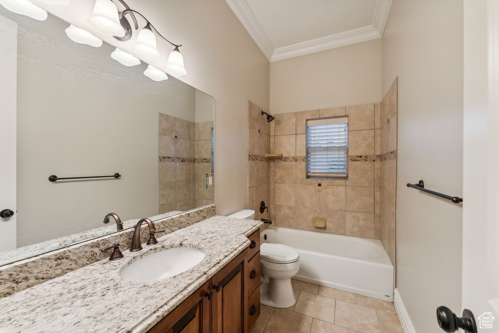 Full bathroom with tiled shower / bath, vanity, tile patterned floors, crown molding, and toilet