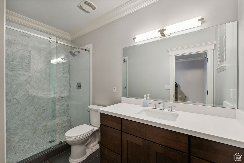 Bathroom with vanity, toilet, ornamental molding, walk in shower, and tile patterned flooring