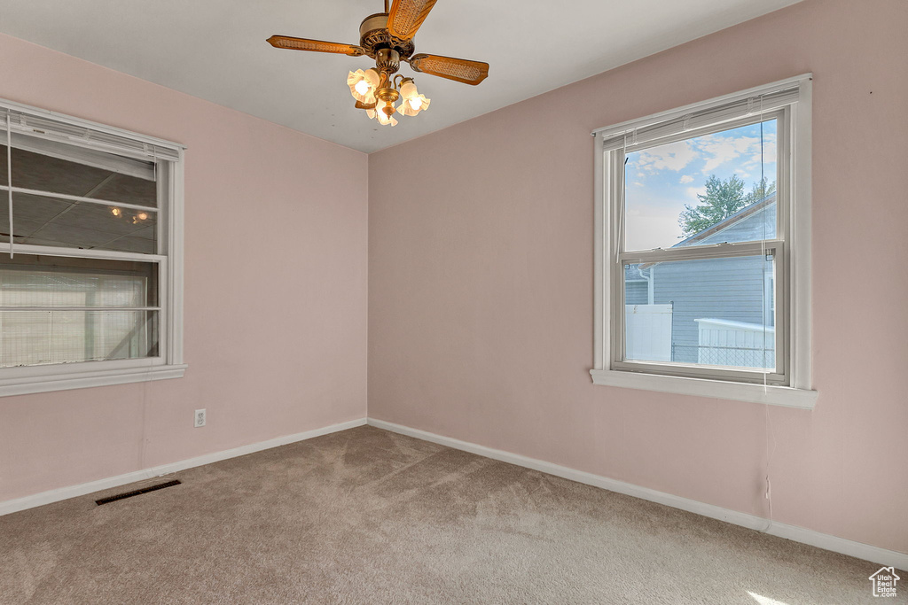 Spare room with light carpet and ceiling fan