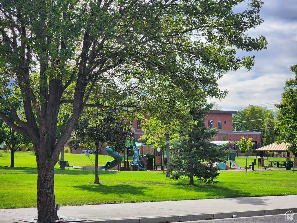 View of community featuring a playground and a lawn