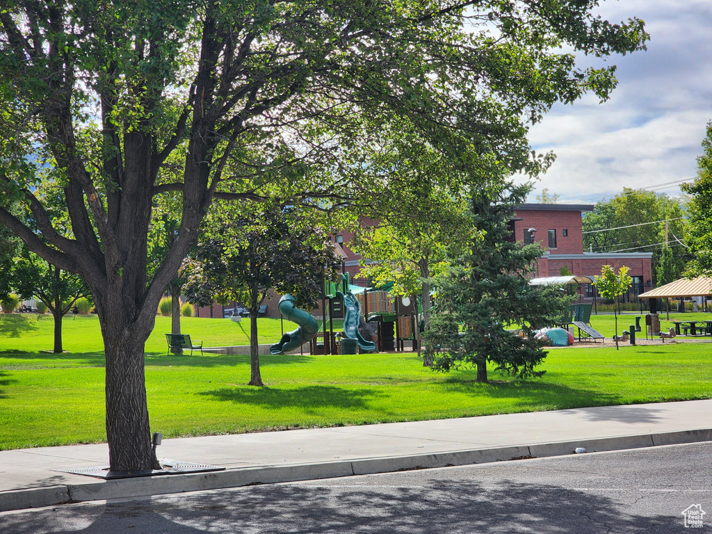 Surrounding community featuring a playground and a yard