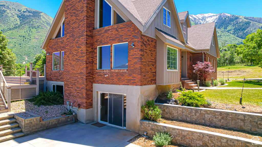 View of side of home featuring a mountain view