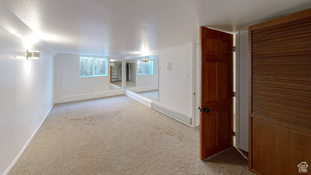 Hall with a textured ceiling and carpet flooring