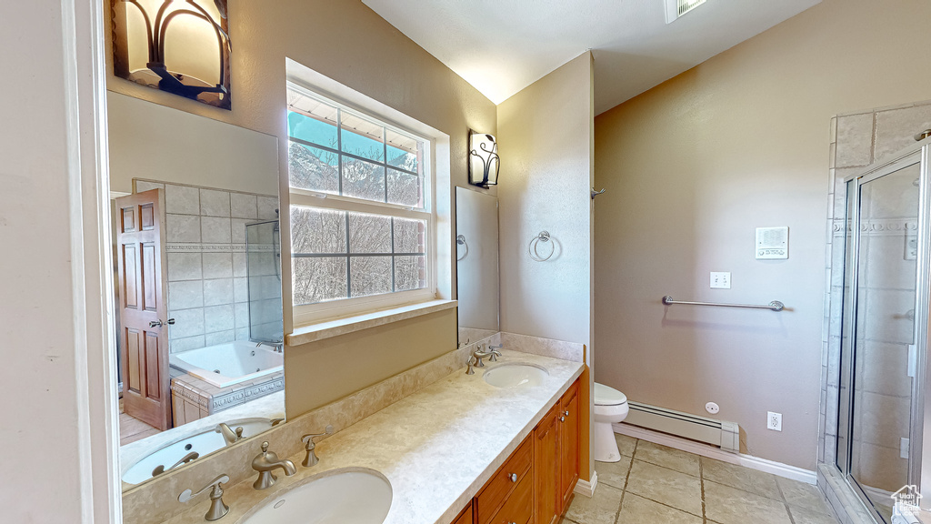 Full bathroom with plus walk in shower, tile patterned flooring, baseboard heating, vanity, and toilet