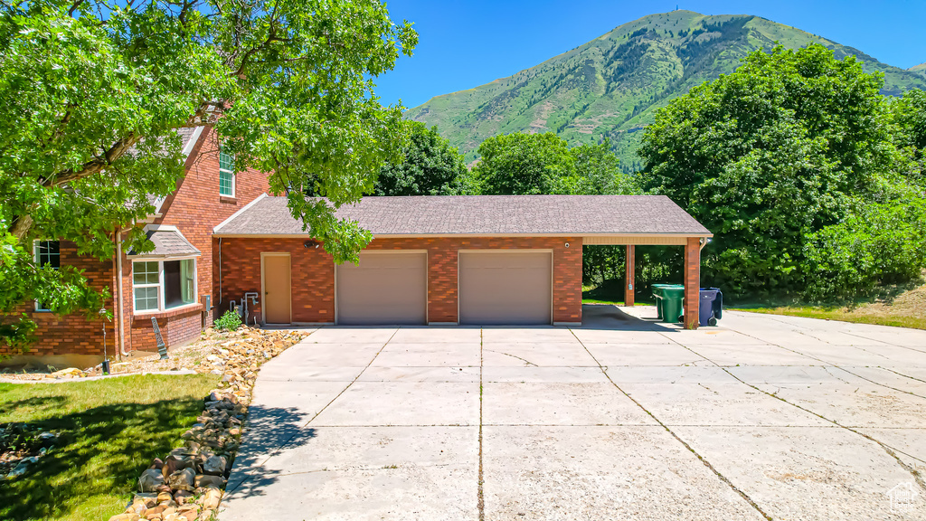 View of front of property featuring a carport and a mountain view