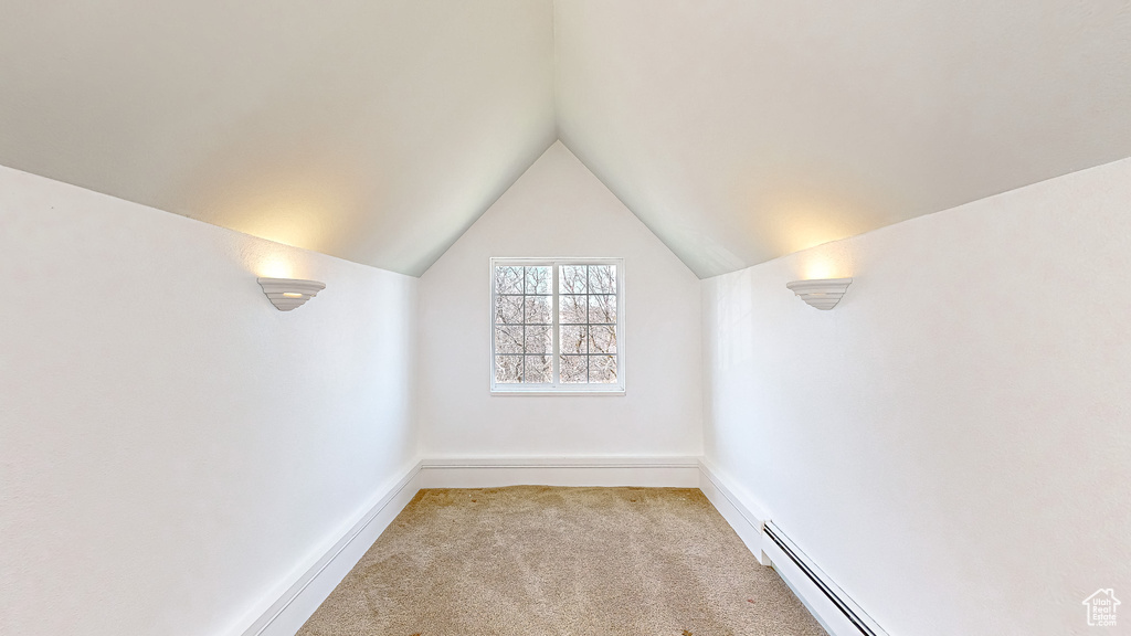 Interior space with light colored carpet and vaulted ceiling