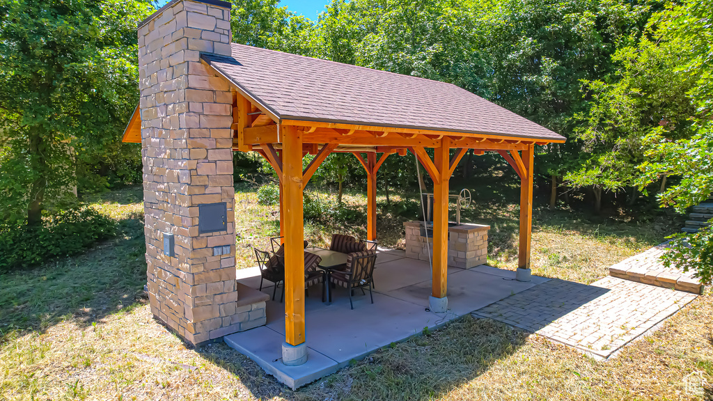 View of property\'s community featuring a lawn, a patio area, and a gazebo