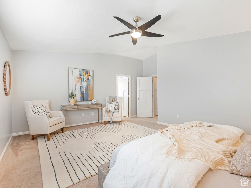 Bedroom with lofted ceiling, ceiling fan, and light colored carpet