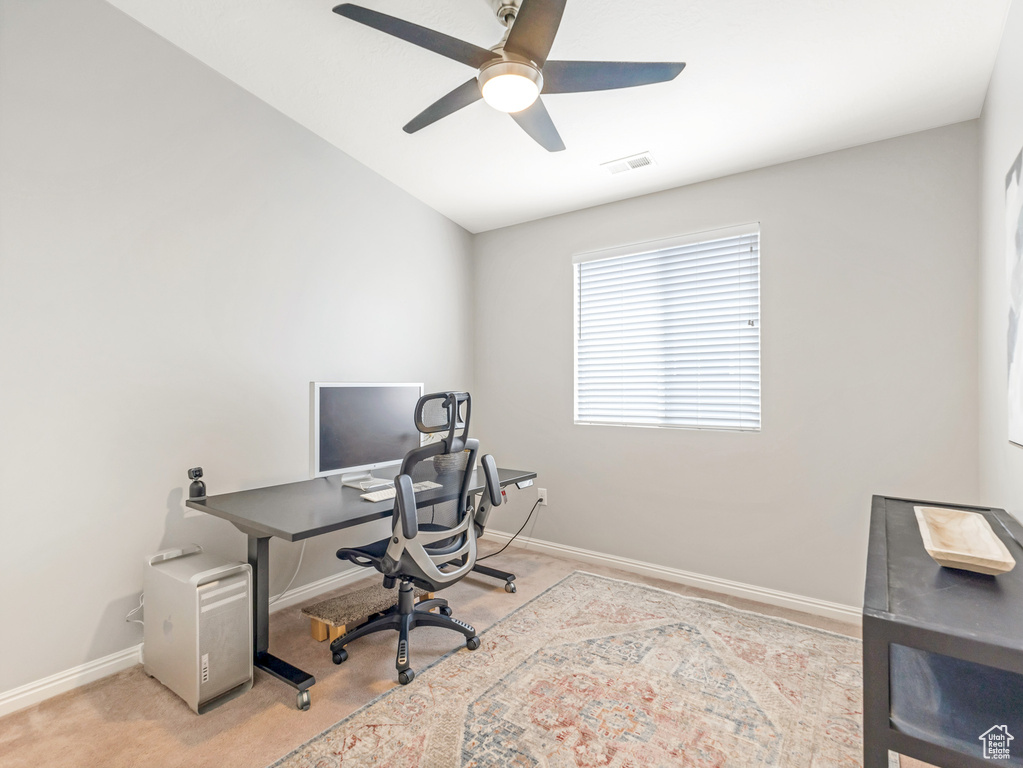 Carpeted office space with ceiling fan