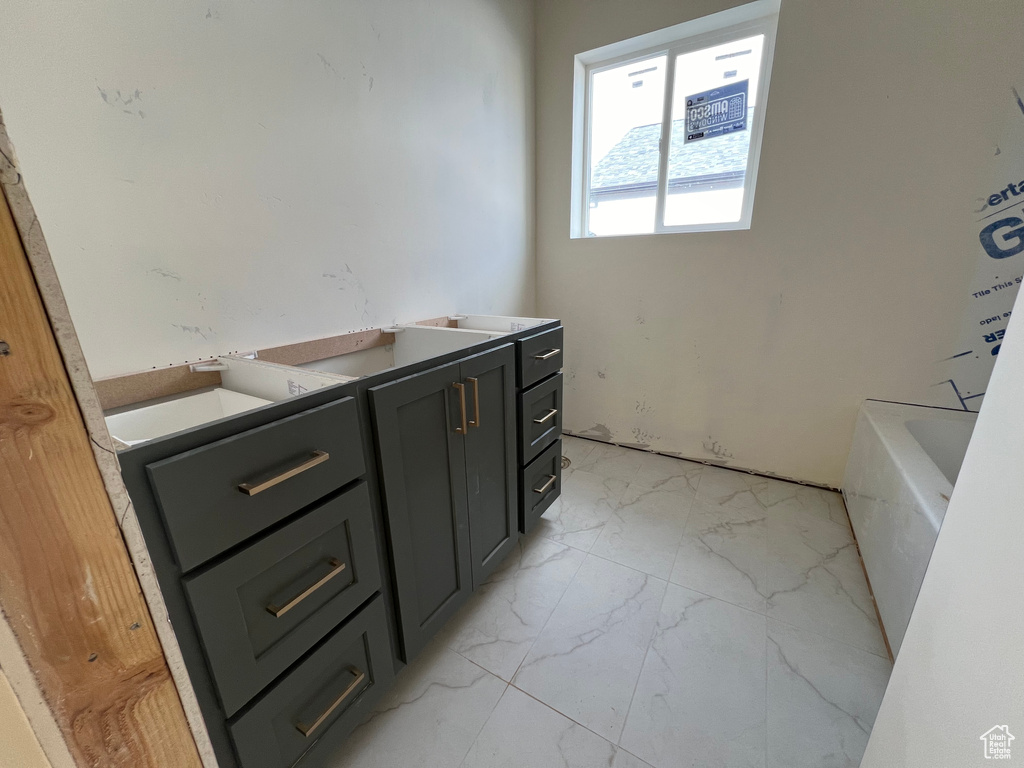 Bathroom with a washtub and vanity