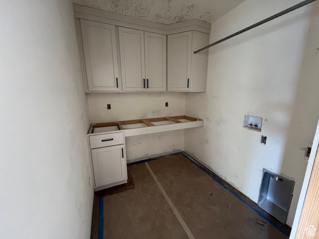 Washroom featuring cabinets and hookup for a washing machine