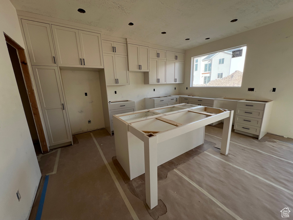 Kitchen featuring white cabinetry and a center island