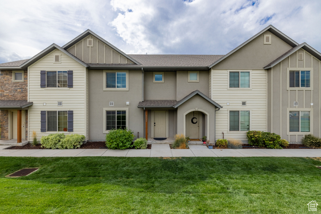 View of property with a front yard