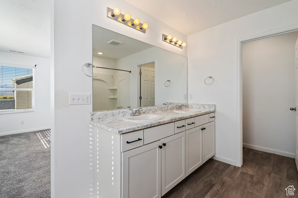 Bathroom with walk in shower, wood-type flooring, a textured ceiling, and vanity