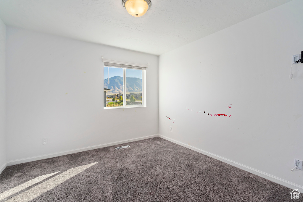 Empty room featuring carpet floors