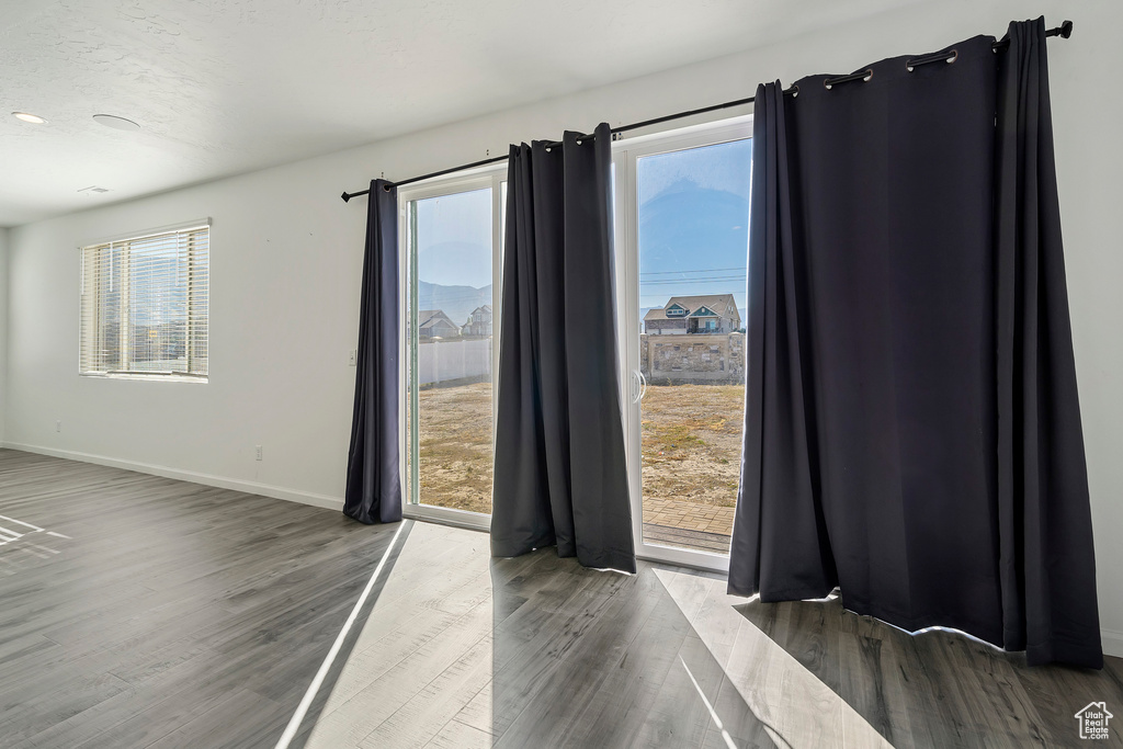 Spare room with dark hardwood / wood-style floors