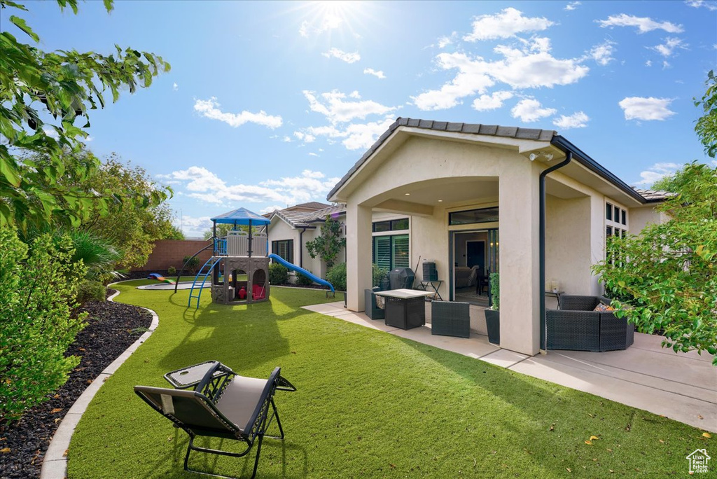 View of yard with a playground and a patio area